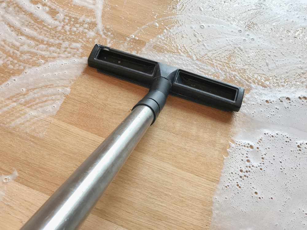 Wood floor being cleaned