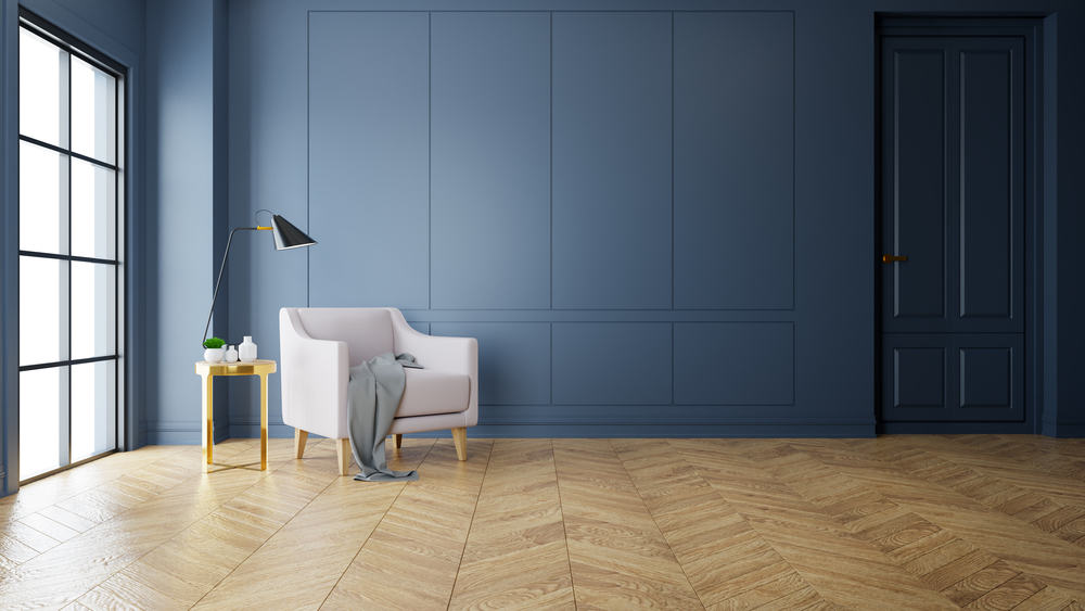 Chevron style flooring with blue wall