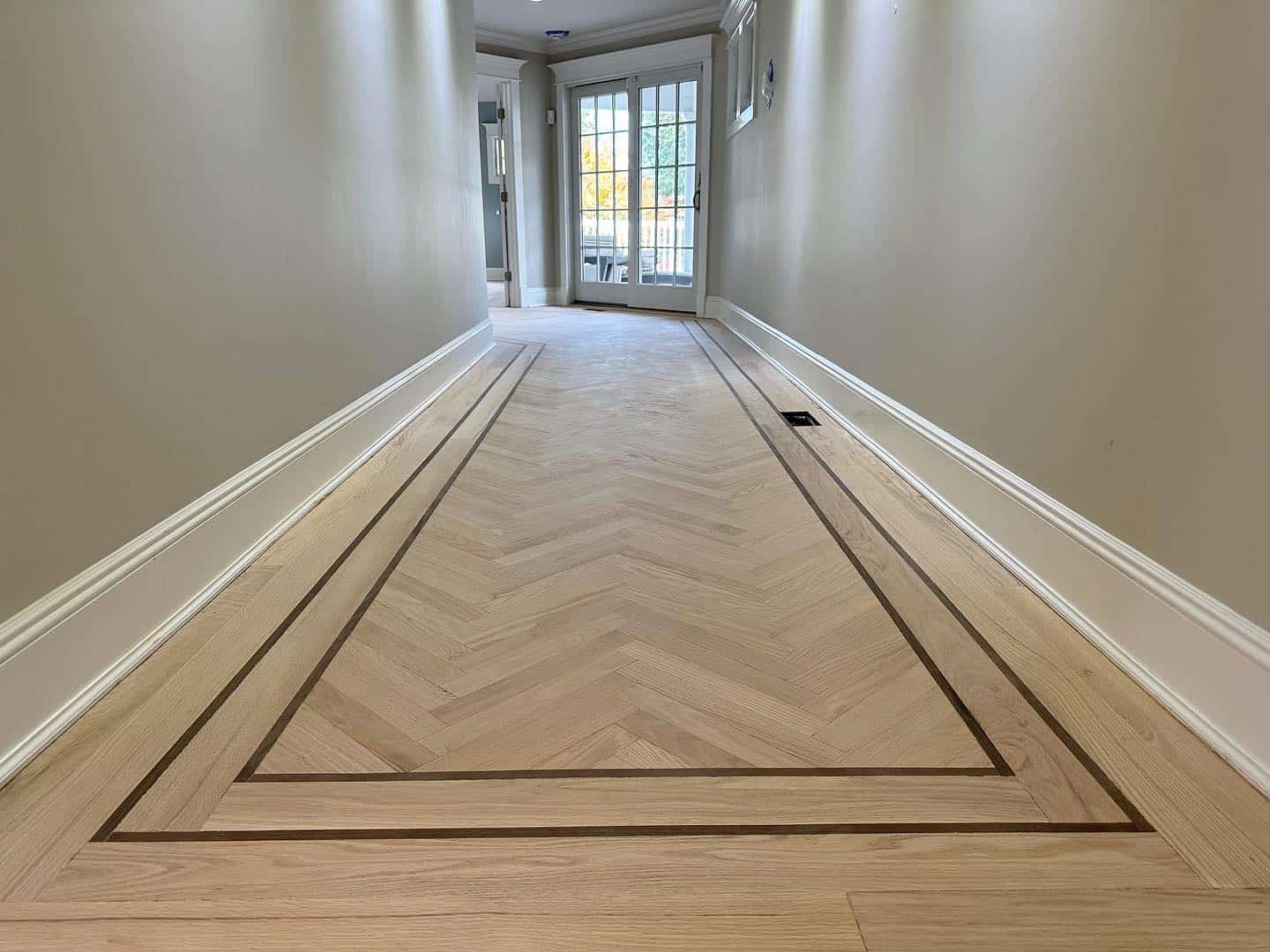 White Oak Herringbone wood flooring installed.