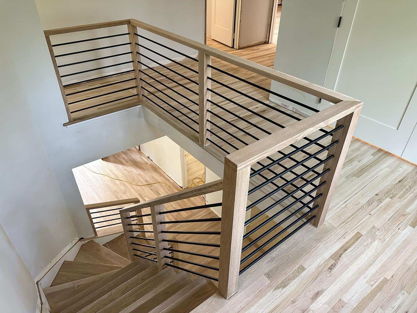 staircase, flooring, and railing crafted by KO Floors.