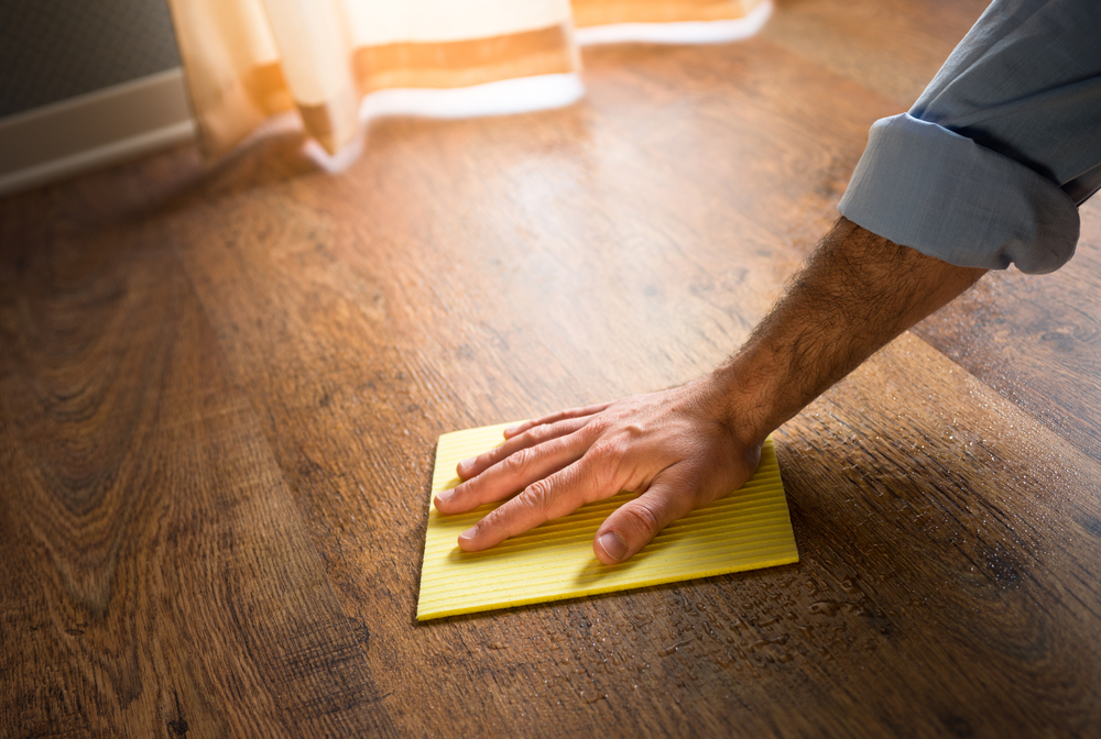A man wiping the Hardwood Floors in Long Island